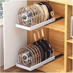 two racks with pots and pans in them on the side of a kitchen counter