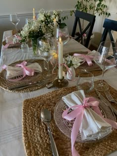 a table set with place settings and flowers