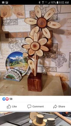 a wooden flower sculpture sitting on top of a table