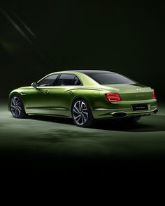 the rear end of a green car on a dark background