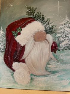 a painting of a santa clause sitting in the snow with pine branches on his head