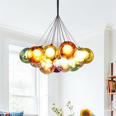 a living room filled with furniture and a chandelier hanging over it's head