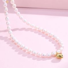 Adorn a youthful vibe with our 5-6mm Oval Rice Pearl Necklace, featuring a charming heart pendant. Ideal for those who love playful and lively styles, this necklace showcases high-luster freshwater pearls in an oval rice shape. It extends from 40cm to 45cm with an adjustable silver extension chain, making it versatile and suitable for any look. Product Details: Pearl Type: Freshwater Rice Pearls Pearl Size: 5-6mm Shape: Oval (Rice) Luster: High Pendant: Heart-shaped Length: 40cm + 5cm Extension White Pearl Drop Necklace For Valentine's Day, Valentine's Day White Pearl Necklace With Charm, White Pearl Heart Pendant Necklace, White Pearl Heart Necklace With Charm, White Pearl Necklace With Heart Charm, White Heart-shaped Pearl Necklace With Charm, White Heart-shaped Pearl Necklace, Pearl White Oval Beads Pearl Necklace For Gift, Pearl White Pearl Necklace With Oval Beads For Gift