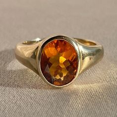 10k yellow gold signet ring by 23carat featuring a beautiful faceted citrine in a bezel setting. Excellent condition Size: 6.75 resizable* Weight: 5.7 grams Band: 11.0 mm (front), 3.0 mm (back) Citrine: 9.0 mm x 8.0 mm oval cut Hallmarks: 10k, water barrel and heart for 23carat Handmade to order, please allow for approximately 1 to 3 weeks before shipping For more details or customization options, emails us at info@shop23carat.com Water Barrel, Jewelry Wardrobe, Gold Signet Ring, Signet Ring, Bezel Setting, Oval Cut, 3 Weeks, Citrine, Barrel