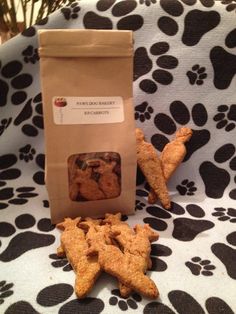 two bags of dog treats sitting on top of a black and white blanket