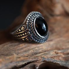 Introducing our Black stone oval onlyx stainless Steel Ring featuring an intricate design and a striking cabochon. This exquisitely crafted piece seamlessly blends timeless elegance with contemporary style. The detailing on the stainless steel band adds a touch of artistry, while the oval onyx stone takes center stage, exuding a sense of mystery and refined charm in the boho hippie style. Whether you're dressing up for a special occasion or adding a touch of intrigue to your everyday look, this Unique Black Stainless Steel Jewelry, Bohemian Oval Metal Rings, Boho Hippie Style, Present For Him, Casual Jewelry, Stainless Steel Ring, Oval Stone, Onyx Stone, Stainless Steel Band