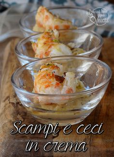 three glass bowls filled with food on top of a wooden table