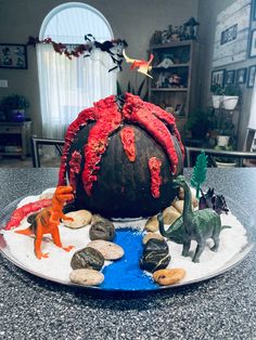 there is a fake pumpkin with dinosaurs on it