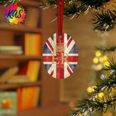 an ornament hanging from a christmas tree decorated with the flag of great britain