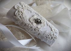 a white lace garter with a flower on it