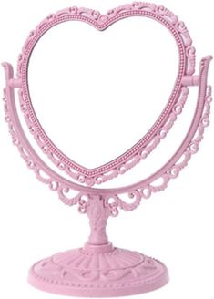 a pink heart shaped mirror on top of a stand