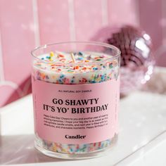 a candle that is sitting on top of a counter with sprinkles in it