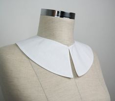 the back of a mannequin wearing a white collar