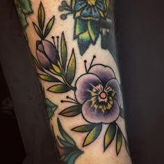 a close up of a person's arm with flowers on it