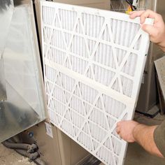 a man is working on a air filter