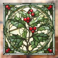 a stained glass window with holly leaves and berries