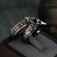 two rings with roman numerals on them sitting on top of a wooden stand