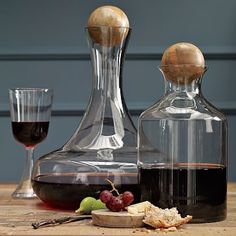 a wine decanter and two glasses are sitting on a table next to each other