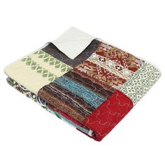 a multicolored patchwork blanket is folded on top of each other