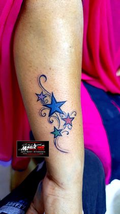 a woman's arm with stars on it and the word star written in blue ink