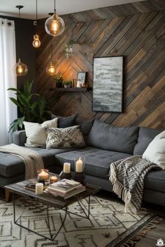 a living room filled with furniture next to a wall covered in wood planks and hanging lights