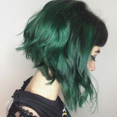 a woman with green hair and black dress