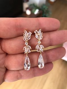 These are dainty, feminine cascading cubic zirconia teardrop wedding earrings. We apply high quality diamond simulant that will make you shine even more in your special day, absolutely goes with everything! These are sparkly and have wow factor so be ready to receive a lot of compliments and even being asked if these are real diamonds. Each stone is carefully prong set, not glued. All earrings features high quality electroplating that does not fade or chip. I am sure you will continue to enjoy t Gold Cubic Zirconia Teardrop Earrings For Wedding, Elegant Rose Gold Teardrop Earrings With Cubic Zirconia, Pear-shaped Cubic Zirconia Earrings For Wedding, Teardrop Cubic Zirconia Bridal Earrings For Wedding, Rose Gold Cubic Zirconia Drop Bridal Earrings, Cubic Zirconia Teardrop Wedding Earrings, Cubic Zirconia Teardrop Earrings For Wedding, Wedding Chandelier Teardrop Earrings Cubic Zirconia, Wedding Teardrop Chandelier Earrings In Cubic Zirconia