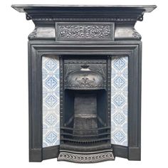 an old fashioned fireplace with blue and white tiles on the front, and a metal chimney