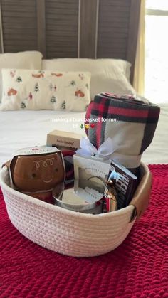 a basket filled with items on top of a bed