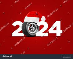 a red and white christmas card with a santa hat on top of a motorcycle tire