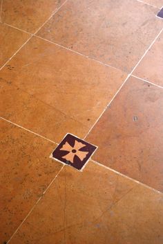 an orange and brown tiled floor with a star on it