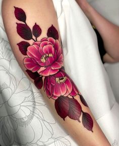 a woman with a flower tattoo on her arm