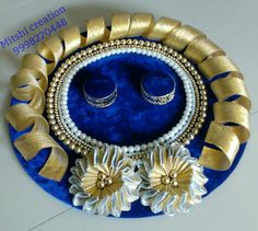 an assortment of jewelry is displayed on a blue plate