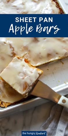 sheet pan apple bars with white icing on top in a baking pan next to a spatula