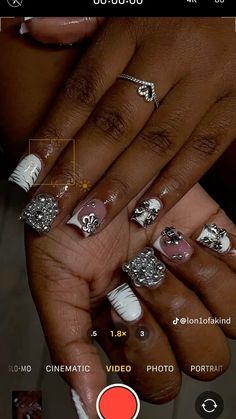 someone is holding their hands with different nail designs on the nails and one has an orange circle