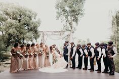 a group of people standing on top of a wooden platform