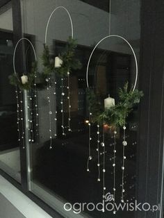 the window is decorated with candles and greenery