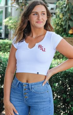 Shopping for cute game day gear? We've got you covered! The FSU Cropped Cali Tee is the perfect addition to your closet. This top features a scoop v-neckline and ribbed material for a comfortable and flattering fit. The school logo on the front gives this tee a sleek and spirited look. Whether heading to class or a tailgate, this top is a must-have! Pair with a cute skirt or shorts for the perfect look! Details: *OFFICIALLY LICENSED* True to Size Stretchy Ribbed Material Scoop V-Neckline 95% cot Cute Game, Girl Fashion Style, Florida State University, School Logo, Sarasota Florida, Cute Skirt, Cute Games, Trendy Clothes For Women, Florida State