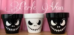 three halloween cups with faces painted on them