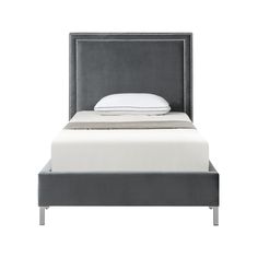 an upholstered bed with white sheets and grey headboard on top of it