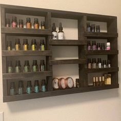 a wooden shelf filled with lots of bottles