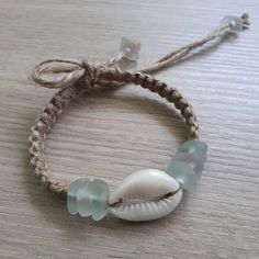 a bracelet with seashells and sea glass beads