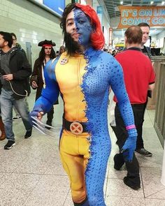 a man dressed as x - men walking through an airport