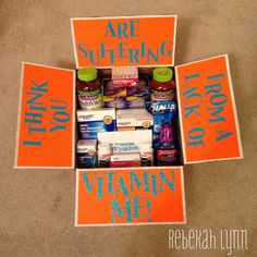 an orange box filled with vitamins and medicine on top of a carpeted floor