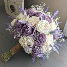 a bridal bouquet with purple and white flowers