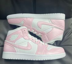 a pair of pink and white high top sneakers