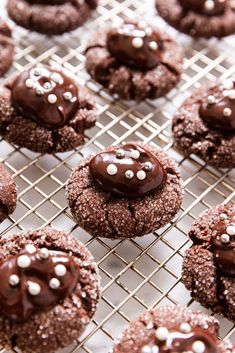 chocolate cookies with white sprinkles on a cooling rack