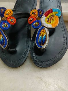 This African beaded Masai sandals are made from leather and beads which comes in different colours of ones choice. It can be customized in terms of size,pattern and colour. They can be worn at any given time, wether in weddings, parties, holidays at the beach and home. Note:This listing is for one pair,  but we do both wholesale and retail Leather And Beads, Beaded Leather Sandals, Sandals Gladiator, Beaded Shoes, Beaded Sandals, African Beads, Bead Leather, Size Pattern, Strappy Sandals