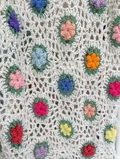 a crocheted blanket with flowers on it