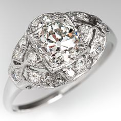 an antique style diamond engagement ring with filigrees